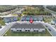 Aerial view of townhome complex featuring multiple units, ample parking, and landscaped common areas near a highway at 4846 Coral Castle Dr, Kissimmee, FL 34746