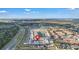 Aerial view of neighborhood showcasing a townhome community near a pond, highway and wooded area at 4846 Coral Castle Dr, Kissimmee, FL 34746