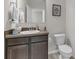 Cozy half bath features modern vanity, mirror, and toilet at 4846 Coral Castle Dr, Kissimmee, FL 34746
