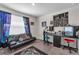 A contemporary bedroom with a sleek black couch, desk, and creative decor at 4846 Coral Castle Dr, Kissimmee, FL 34746