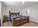 Spacious bedroom featuring a wooden bed frame, carpeted flooring, and an ensuite bathroom at 4846 Coral Castle Dr, Kissimmee, FL 34746
