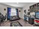 This contemporary bedroom is decorated with black furniture, bright curtains, and gaming artwork at 4846 Coral Castle Dr, Kissimmee, FL 34746