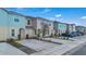 Street view of townhomes, with tidy landscaping and parking, under a sunny sky at 4846 Coral Castle Dr, Kissimmee, FL 34746