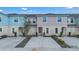 Charming townhomes feature colorful exteriors, well-manicured landscaping, and private driveways at 4846 Coral Castle Dr, Kissimmee, FL 34746