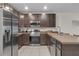 Modern kitchen boasts stainless appliances, dark cabinets, and ample counter space at 4846 Coral Castle Dr, Kissimmee, FL 34746