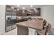 Modern kitchen features stainless steel appliances, dark cabinetry, and breakfast bar at 4846 Coral Castle Dr, Kissimmee, FL 34746