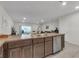 Kitchen with stainless appliances, breakfast bar, and open layout to living area at 4846 Coral Castle Dr, Kissimmee, FL 34746