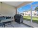Enclosed patio area with grill, table and chairs provides an outdoor space for relaxation and entertaining at 4846 Coral Castle Dr, Kissimmee, FL 34746