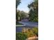 Gated community entrance with lush landscaping and clear signage at 5116 Conroy Rd # 12, Orlando, FL 32811