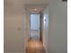 Neutral hallway showcasing multiple closets and access to various rooms at 5116 Conroy Rd # 12, Orlando, FL 32811