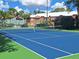 Outdoor tennis court with a view of the surrounding community and blue skies at 5116 Conroy Rd # 12, Orlando, FL 32811