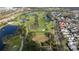 An aerial shot of a community with a golf course and various amenities including ponds and lush landscaping at 614 Golfpark Dr, Kissimmee, FL 34747