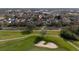 An aerial view of a home near a golf course, showcasing the surrounding green landscape and community layout at 614 Golfpark Dr, Kissimmee, FL 34747