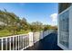 Spacious balcony with white railings offering views of lush landscaping and blue skies at 614 Golfpark Dr, Kissimmee, FL 34747