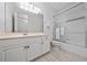 Well-lit bathroom featuring a vanity, toilet, and shower with glass doors at 614 Golfpark Dr, Kissimmee, FL 34747