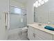 Bright bathroom featuring a shower with glass doors and a white sink vanity at 614 Golfpark Dr, Kissimmee, FL 34747