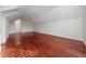 Large bonus room with red hardwood floors and a ceiling fan at 614 Golfpark Dr, Kissimmee, FL 34747