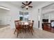 Bright breakfast nook with a round wood table, four chairs, tile floors, and a ceiling fan at 614 Golfpark Dr, Kissimmee, FL 34747