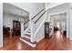 Elegant foyer with hardwood floors, a staircase with white spindles, and views to the dining and living rooms at 614 Golfpark Dr, Kissimmee, FL 34747