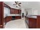 Gourmet kitchen with dark wood cabinets, modern appliances, and a spacious island for cooking and entertaining at 614 Golfpark Dr, Kissimmee, FL 34747