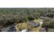 An aerial view displays the home's backyard adjacent to a large green space at 6495 Eve St, St Cloud, FL 34771