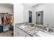 Bathroom with a large vanity, dual sinks, and walk-in closet at 6495 Eve St, St Cloud, FL 34771