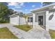 Inviting home entrance featuring a brick walkway leading to a covered porch and a view into the bright interior at 6495 Eve St, St Cloud, FL 34771