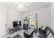 Inviting living room with sleek black furniture and a large window at 6495 Eve St, St Cloud, FL 34771