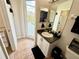 Bright bathroom featuring a double mirror, and direct access to the pool, sink with granite countertop and a toilet at 650 Tuscan Hills Blvd, Davenport, FL 33897