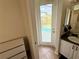 Bright bathroom featuring a door leading to a pool area and a vanity with granite countertops at 650 Tuscan Hills Blvd, Davenport, FL 33897