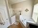 Bathroom featuring a soaking tub with shower head and white tiling at 650 Tuscan Hills Blvd, Davenport, FL 33897