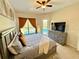 Bedroom features a large bed, a view of a pool, and natural light at 650 Tuscan Hills Blvd, Davenport, FL 33897