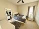 A bedroom with a bed and an ensuite bathroom, with matching nightstands and a carpeted floor at 650 Tuscan Hills Blvd, Davenport, FL 33897