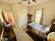 Bedroom featuring a twin bed, dark wood dresser, closet, ceiling fan, and window at 650 Tuscan Hills Blvd, Davenport, FL 33897