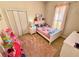 A bedroom featuring a twin bed, white nightstand, white closet, and pink rug at 650 Tuscan Hills Blvd, Davenport, FL 33897