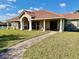 Community clubhouse featuring a red tiled roof, large grassy area and sidewalks at 650 Tuscan Hills Blvd, Davenport, FL 33897