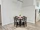 Dining area with modern chandelier and seating for four, next to the living room at 650 Tuscan Hills Blvd, Davenport, FL 33897