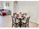 Cozy dining area with a round table, four chairs, and a modern chandelier at 650 Tuscan Hills Blvd, Davenport, FL 33897