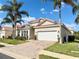 Charming single-story home with a tile roof, lush landscaping, and a two-car garage at 650 Tuscan Hills Blvd, Davenport, FL 33897