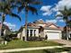 Charming single-story home with a tile roof, lush landscaping, and a two-car garage at 650 Tuscan Hills Blvd, Davenport, FL 33897