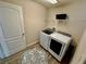 Well-lit laundry room featuring a modern washer and dryer, and a stylish rug at 650 Tuscan Hills Blvd, Davenport, FL 33897