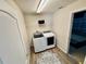 Well-lit laundry room featuring a modern washer and dryer, and a stylish rug at 650 Tuscan Hills Blvd, Davenport, FL 33897