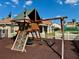 Playground featuring a climbing wall, swings, and a covered play structure at 650 Tuscan Hills Blvd, Davenport, FL 33897