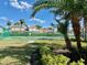 Community tennis court surrounded by lush landscaping and mature palm trees at 650 Tuscan Hills Blvd, Davenport, FL 33897