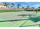 Community tennis court with palm trees and residential houses in the background at 650 Tuscan Hills Blvd, Davenport, FL 33897