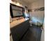 Modern bathroom featuring gray tiles, vanity with storage, and a glass-enclosed shower at 710 E Arizona Ave # A, Deland, FL 32724