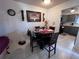 Cozy dining area featuring a round table, wooden chairs, and decorative wall art at 710 E Arizona Ave # A, Deland, FL 32724