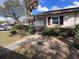 Single-story home with landscaped front yard, green shrubbery, and concrete walkway at 710 E Arizona Ave # A, Deland, FL 32724