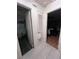 Hallway leading to the bathroom and bedroom, with neutral tile and a linen closet at 710 E Arizona Ave # A, Deland, FL 32724