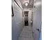Bright hallway with tile flooring, closet space, and access to the bathroom and other rooms at 710 E Arizona Ave # A, Deland, FL 32724
